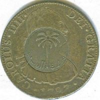 Obverse of a coin of 8 reales (silver) of Carlos IV of 1797 with coin of Saudi Arabia.